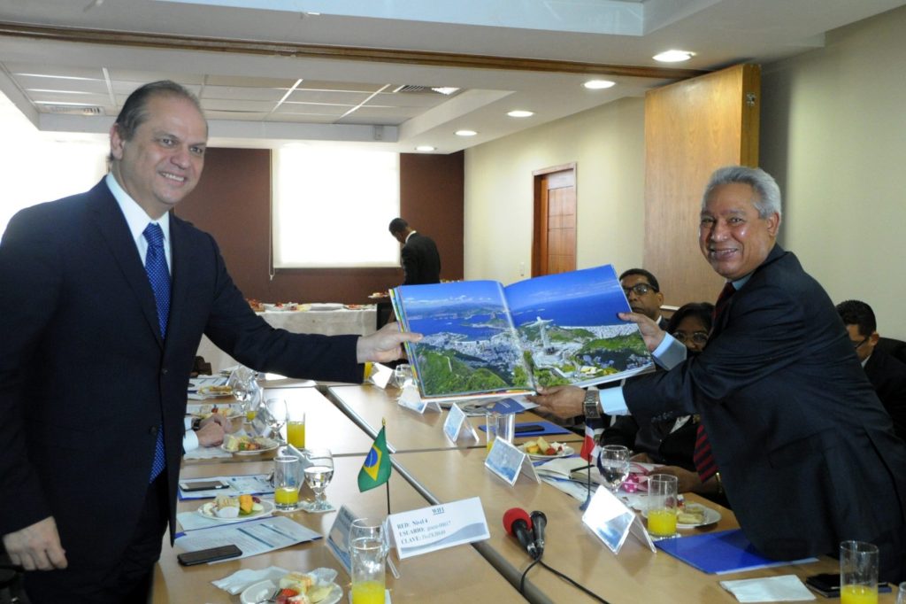 El ministro de salud de Brasil, Roberto Barros, entrega al ministro Isidoro Santana, rector de la cooperación internacional en el país, un álbum estampado con la escultura del “Cristo Redentor”, situada sobre el cerro de Corcovado, en Río de Janeiro.